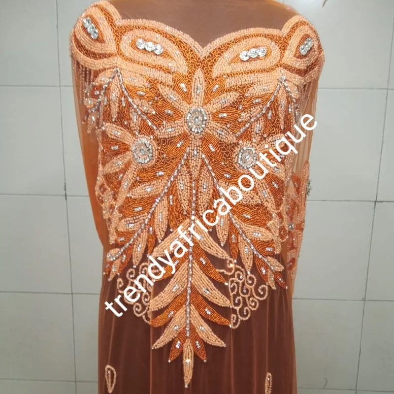 Orange color Heavily-beaded net for making blouses. Popularly use by Igbo/Delta/edo women for making modern big Occasion BlouseComes in 1.8yds lenght already design for your beautiful blouse Peter Pan Blouse